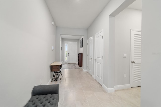 hall featuring light tile patterned floors