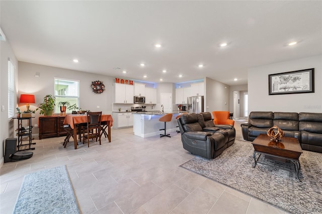 tiled living room featuring sink