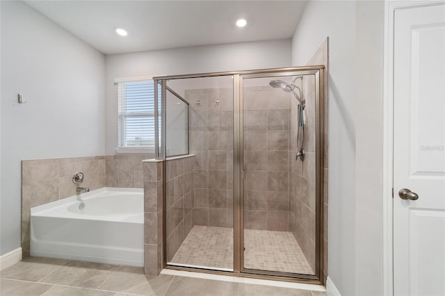 bathroom featuring tile patterned flooring and separate shower and tub