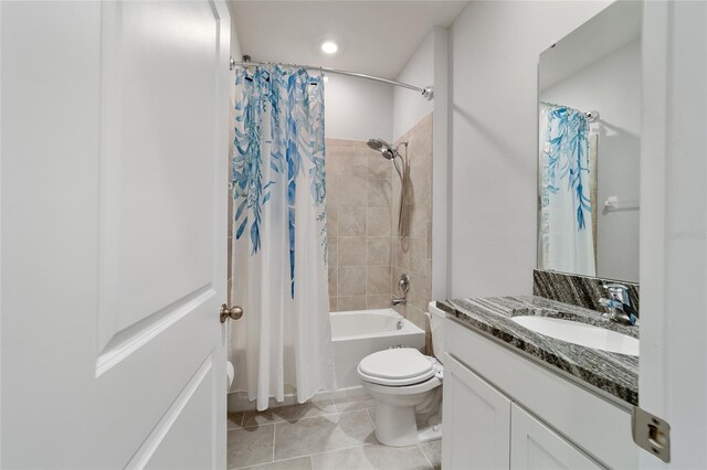 full bathroom with shower / bath combination with curtain, tile patterned flooring, vanity, and toilet