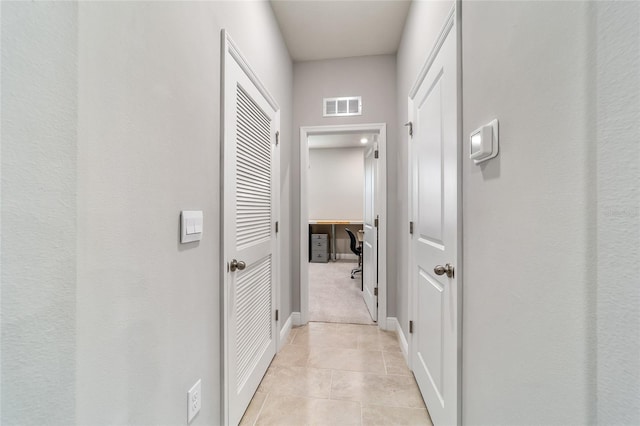 corridor with light tile patterned floors