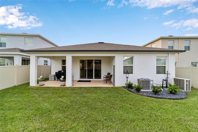 rear view of property with a patio and a lawn