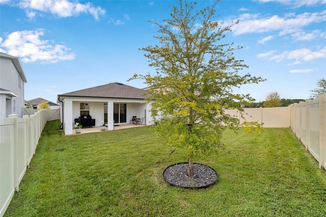 back of property with a lawn and a patio area