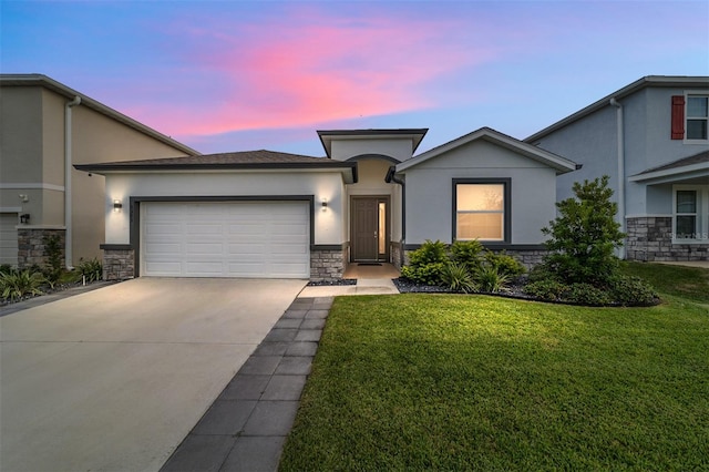 view of front of property featuring a garage and a yard