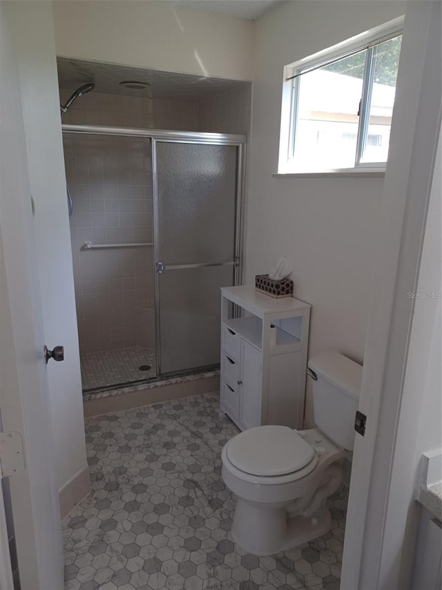 bathroom featuring vanity, toilet, and an enclosed shower