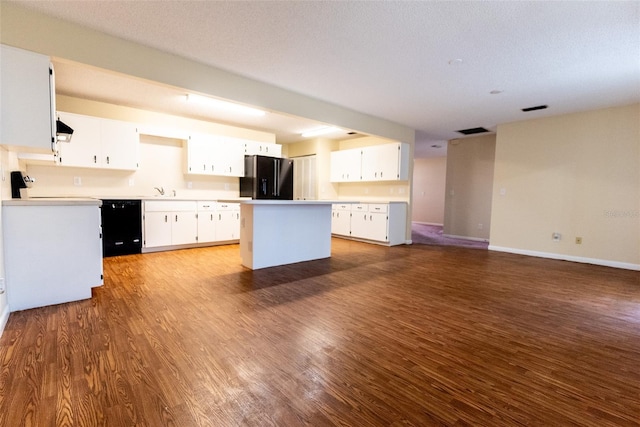 kitchen with a kitchen island, black appliances, dark hardwood / wood-style floors, and white cabinets