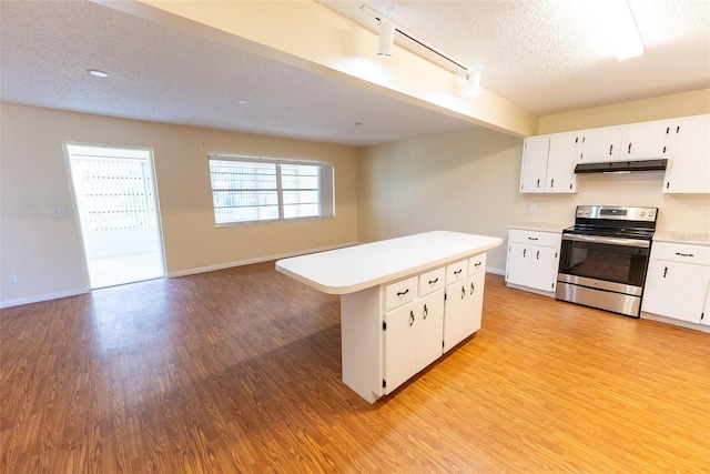 kitchen with a center island, white cabinets, electric stove, light hardwood / wood-style flooring, and a textured ceiling