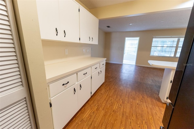 kitchen with white cabinets and light wood-type flooring