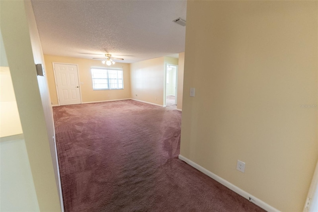 empty room with carpet floors, a textured ceiling, and ceiling fan