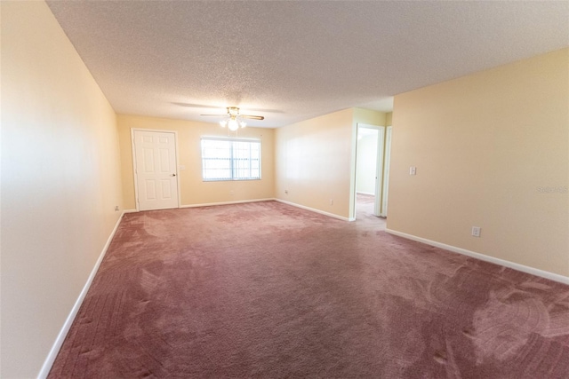 carpeted spare room with a textured ceiling and ceiling fan