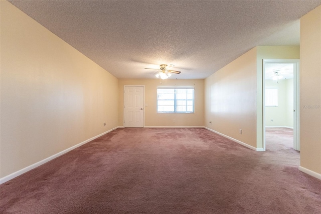 spare room with ceiling fan, a textured ceiling, and carpet flooring