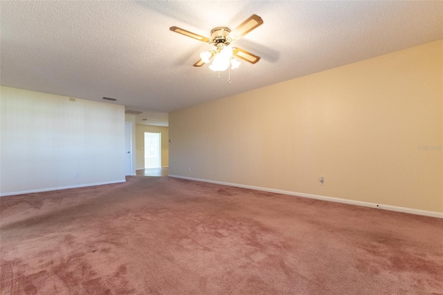 carpeted spare room featuring ceiling fan and a textured ceiling