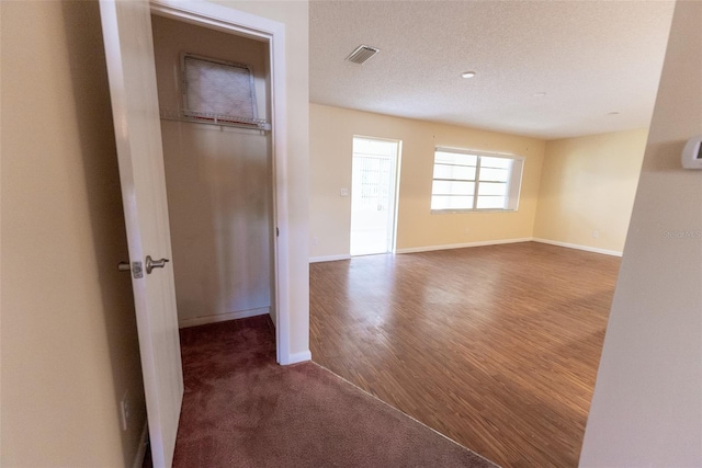 spare room with wood-type flooring and a textured ceiling