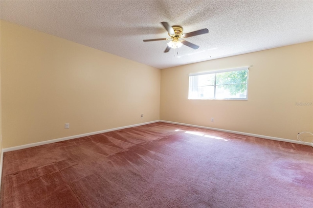 carpeted empty room with ceiling fan and a textured ceiling