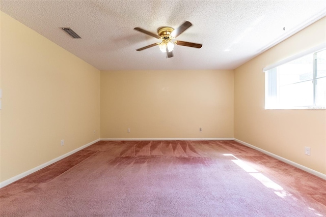 spare room with ceiling fan, carpet, and a textured ceiling