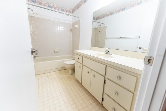 full bathroom featuring tiled shower / bath combo, vanity, and toilet