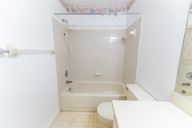 full bathroom featuring vanity, tiled shower / bath combo, and toilet