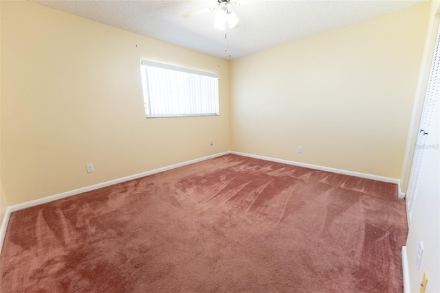 unfurnished room featuring ceiling fan and carpet