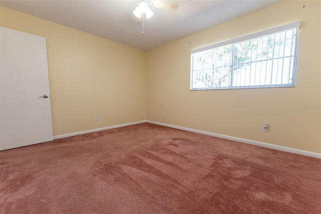 unfurnished room featuring carpet, a textured ceiling, and ceiling fan