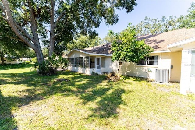 view of yard with a sunroom and central AC