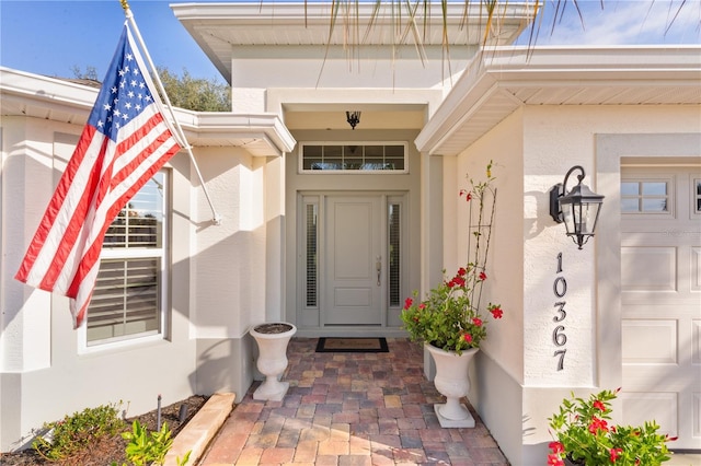 view of exterior entry featuring a garage