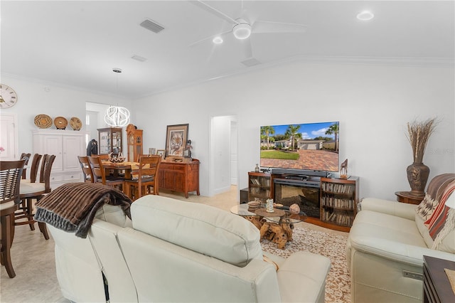 living room featuring ornamental molding, vaulted ceiling, and ceiling fan