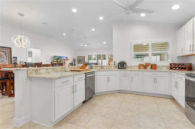 kitchen featuring appliances with stainless steel finishes, light tile patterned flooring, lofted ceiling, decorative light fixtures, and white cabinets