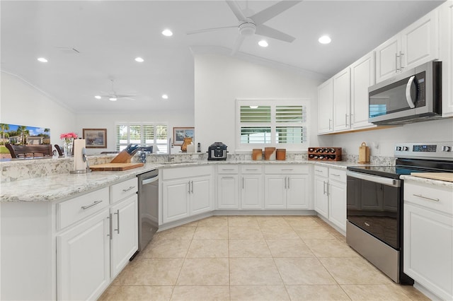 kitchen with white cabinetry, appliances with stainless steel finishes, lofted ceiling, and kitchen peninsula