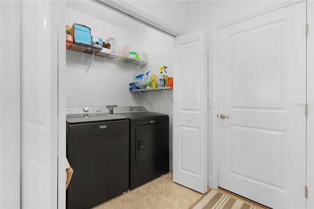 washroom featuring separate washer and dryer and light tile patterned floors