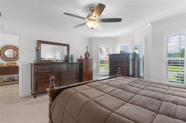 bedroom with ceiling fan, crown molding, and light colored carpet