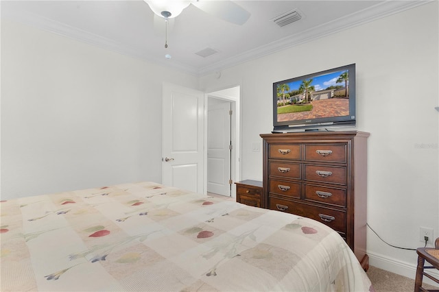 carpeted bedroom featuring ornamental molding and ceiling fan