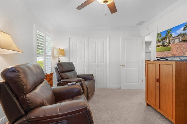 living room with light carpet, ornamental molding, and ceiling fan