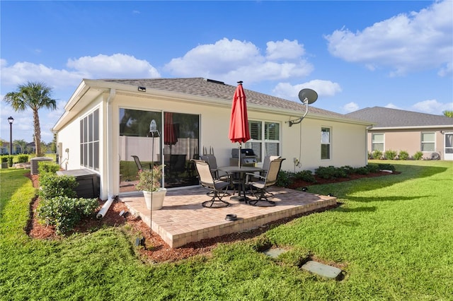 back of property with a patio and a lawn