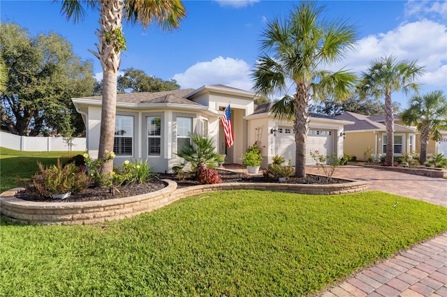 view of front of house featuring a front yard and a garage