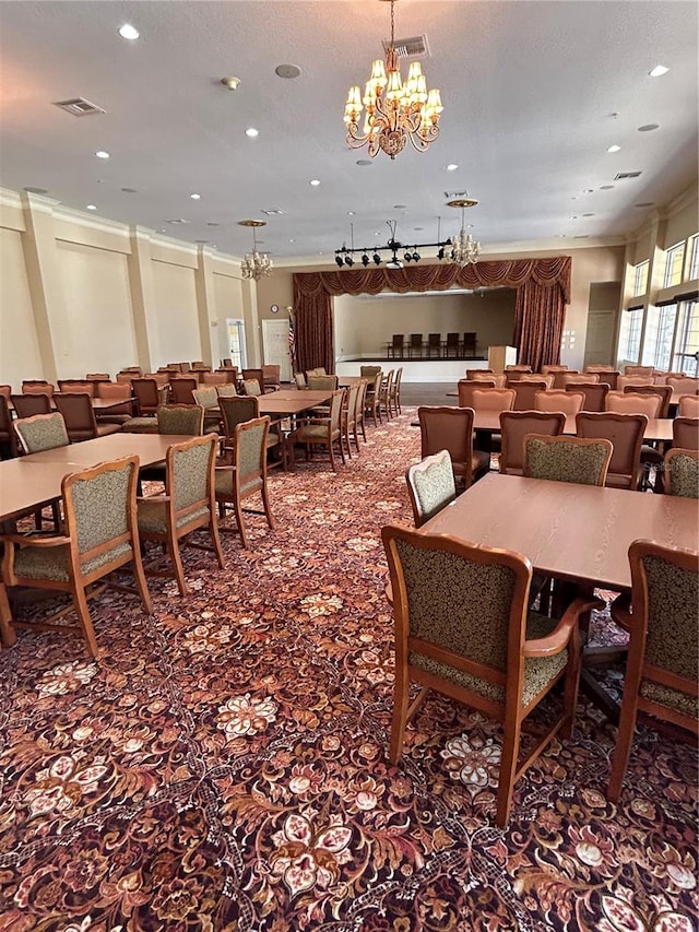 dining room with ornamental molding, carpet, and a notable chandelier