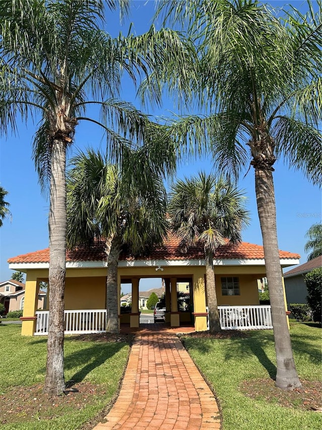 view of front of house with a porch and a front lawn