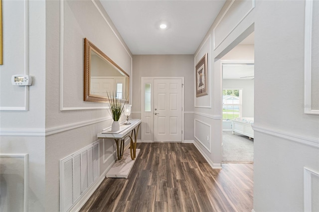 entryway with dark hardwood / wood-style flooring