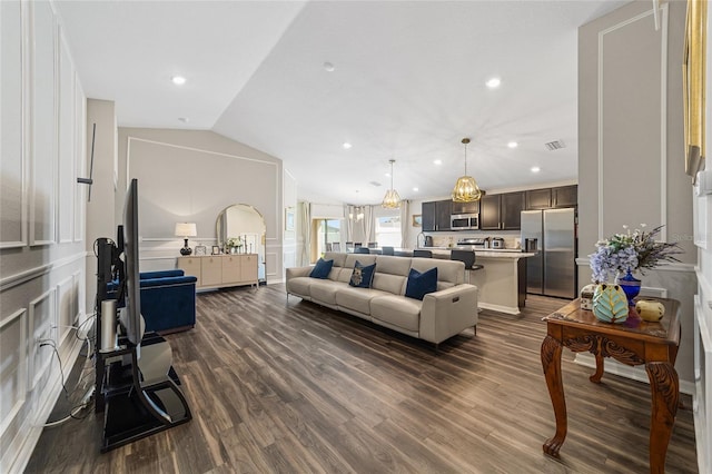 living room with lofted ceiling and dark hardwood / wood-style flooring