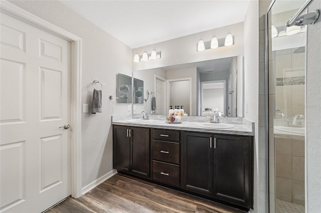 bathroom featuring walk in shower, vanity, and hardwood / wood-style floors