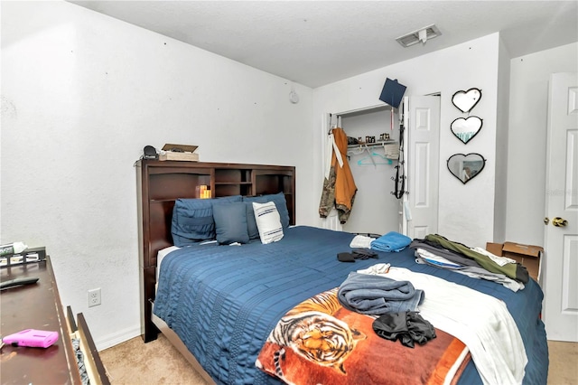 bedroom featuring light carpet and a closet