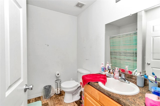 bathroom featuring vanity, toilet, and a shower with shower curtain