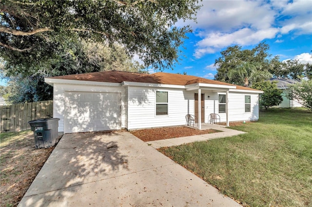 single story home featuring a garage and a front yard