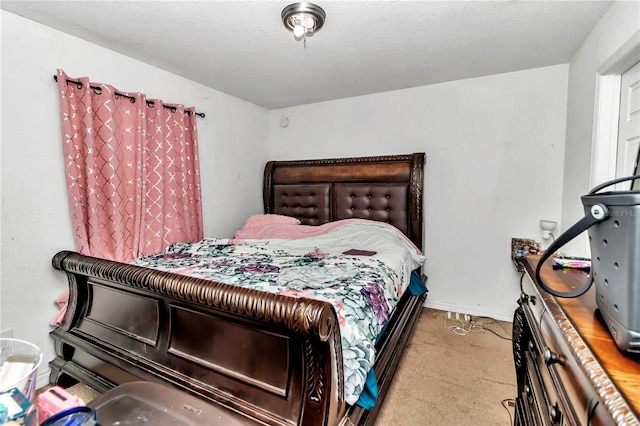 carpeted bedroom featuring a textured ceiling