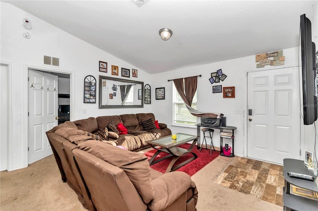 living room featuring lofted ceiling and light colored carpet