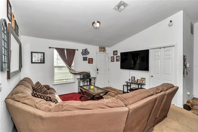 living room featuring lofted ceiling and hardwood / wood-style floors