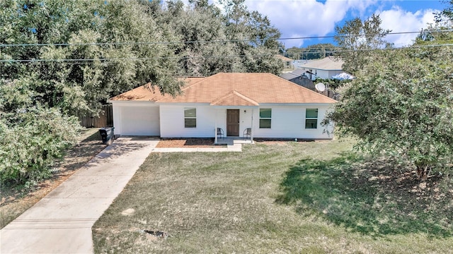 view of front of home with a garage and a front lawn