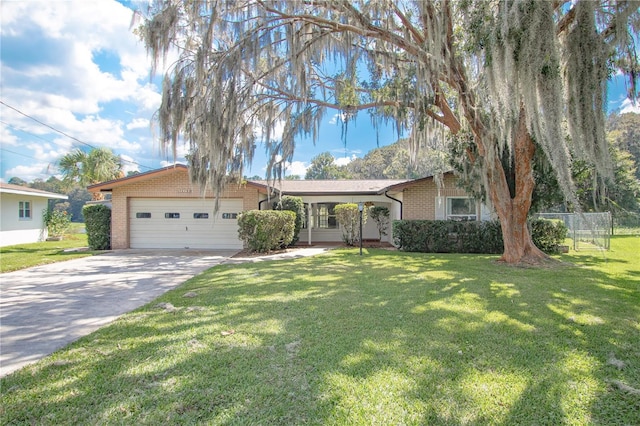 ranch-style home featuring a garage and a front lawn