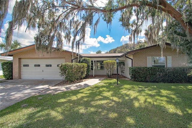 ranch-style home with a garage and a front lawn