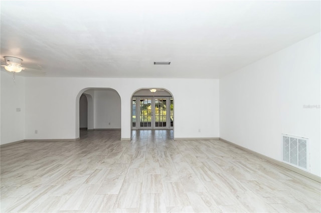 empty room featuring ceiling fan and light hardwood / wood-style floors