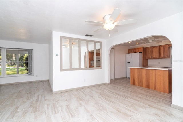 unfurnished living room with ceiling fan and light hardwood / wood-style flooring